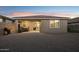 Charming backyard with covered patio, gravel landscaping, and space for outdoor living and dining at sunset at 12176 E Chevelon Trl, Gold Canyon, AZ 85118