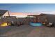 Backyard with decorative patio lights, seating, and a small pool, perfect for relaxation and entertainment at 12176 E Chevelon Trl, Gold Canyon, AZ 85118