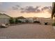 Desert landscaped backyard with BBQ, block wall, mature landscaping, and lounge area at 12176 E Chevelon Trl, Gold Canyon, AZ 85118