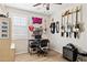 Creative music room with multiple guitars on display, a workspace, and wood-look tile flooring, ideal for musicians at 12176 E Chevelon Trl, Gold Canyon, AZ 85118