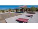 Community common area for residents with cornhole boards and a covered gazebo with picnic tables at 12176 E Chevelon Trl, Gold Canyon, AZ 85118