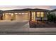 Charming home with three car garage, desert landscaping, and brick column detail at 12176 E Chevelon Trl, Gold Canyon, AZ 85118