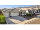 Beautiful house featuring desert landscaping, and a three-car garage against a mountain backdrop at 12176 E Chevelon Trl, Gold Canyon, AZ 85118