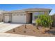 Charming home with three car garage, desert landscaping, and brick column detail at 12176 E Chevelon Trl, Gold Canyon, AZ 85118