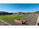 Community horseshoe game area with lush green grass, framed by mountain views, and desert landscaping at 12176 E Chevelon Trl, Gold Canyon, AZ 85118