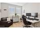 A cozy home office featuring a modern desk, chair, and natural lighting from shuttered windows at 12176 E Chevelon Trl, Gold Canyon, AZ 85118