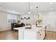 Bright kitchen with island, pendant lighting, stainless steel sink, breakfast nook with plantation shutters at 12176 E Chevelon Trl, Gold Canyon, AZ 85118
