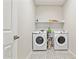 Well-equipped laundry room with modern washer and dryer units, complemented by stylish patterned tile flooring at 12176 E Chevelon Trl, Gold Canyon, AZ 85118