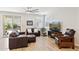 Bright living room boasts leather sofas, media center with fireplace, tile floors, and lots of natural light at 12176 E Chevelon Trl, Gold Canyon, AZ 85118