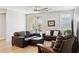 Stylish living room featuring leather seating, tile floors, plantation shutters and sliding glass doors at 12176 E Chevelon Trl, Gold Canyon, AZ 85118