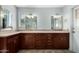 A bathroom featuring dual sinks, custom cabinets, and granite counters at 12811 N 44Th Dr, Glendale, AZ 85304