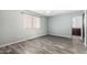 A spacious bedroom features light blue walls and wood look floors at 12811 N 44Th Dr, Glendale, AZ 85304