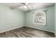 Bright bedroom featuring wood-look flooring and a window at 12811 N 44Th Dr, Glendale, AZ 85304