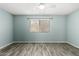 A bright bedroom with a ceiling fan, window, and wood look floors at 12811 N 44Th Dr, Glendale, AZ 85304