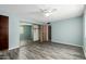 A light-filled bedroom featuring light blue walls, modern ceiling fan, and wood look floors at 12811 N 44Th Dr, Glendale, AZ 85304