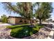 Landscaped front yard featuring artificial grass for easy maintenance in xeriscaped yard at 12811 N 44Th Dr, Glendale, AZ 85304