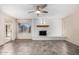 Spacious living room with a brick fireplace, ceiling fan and large window with access to the pool at 12811 N 44Th Dr, Glendale, AZ 85304