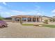 Spacious backyard featuring desert landscaping, stone accents, and a covered patio area for relaxing and entertaining at 17179 S 174Th S Dr, Goodyear, AZ 85338