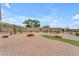 Beautiful backyard with desert landscaping, gravel, a fire pit, and a brick-paved patio at 17179 S 174Th S Dr, Goodyear, AZ 85338