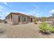 A view of the backyard that includes xeriscaping, a covered patio, and desert plants for an arid environment at 17179 S 174Th S Dr, Goodyear, AZ 85338