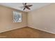 Neutral bedroom with ceiling fan, plush carpeting, and natural light from a window at 17179 S 174Th S Dr, Goodyear, AZ 85338