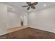 A spacious bedroom with carpet flooring, ceiling fan, and access to an en-suite bathroom at 17179 S 174Th S Dr, Goodyear, AZ 85338