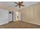 Bright bedroom with closet, ceiling fan, and neutral carpet, creating a calm and comfortable space at 17179 S 174Th S Dr, Goodyear, AZ 85338