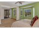 Bright bedroom with neutral carpet, large windows, and access to the outdoor patio area at 17179 S 174Th S Dr, Goodyear, AZ 85338