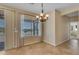 Bright dining room with elegant chandelier and views of the desert landscape at 17179 S 174Th S Dr, Goodyear, AZ 85338