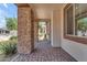Inviting entryway featuring stone columns, paver flooring, and a view of the landscaped front yard at 17179 S 174Th S Dr, Goodyear, AZ 85338