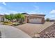 Charming single-Gathering home with a two-car garage, stone accents, and a well-maintained paver driveway at 17179 S 174Th S Dr, Goodyear, AZ 85338