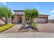 Charming single-story home with stone accents, a well-manicured yard, and a two-car garage at 17179 S 174Th S Dr, Goodyear, AZ 85338