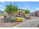 Well-manicured front yard showcasing lush landscaping, mature trees, and a paver driveway leading to the home at 17179 S 174Th S Dr, Goodyear, AZ 85338