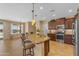 Elegant kitchen featuring granite countertops, wooden cabinets, stainless steel appliances, and barstool seating at 17179 S 174Th S Dr, Goodyear, AZ 85338
