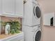 Laundry area featuring stacked washer and dryer with storage cabinets and tasteful decor at 17179 S 174Th S Dr, Goodyear, AZ 85338