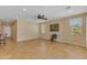 Spacious living room with tile flooring, ceiling fan, and bright natural light at 17179 S 174Th S Dr, Goodyear, AZ 85338