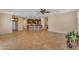 Open living space with tile flooring and a seamless transition to the kitchen and breakfast bar at 17179 S 174Th S Dr, Goodyear, AZ 85338