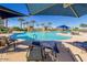 Community pool area with lounge chairs, umbrellas, and shaded seating at 17179 S 174Th S Dr, Goodyear, AZ 85338
