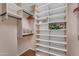 Custom walk-in closet with built-in shelving and ample storage space at 17179 S 174Th S Dr, Goodyear, AZ 85338
