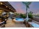 Backyard oasis with pool, spa, covered patio, built-in grill, and lush landscaping at 17363 W Lisbon Ln, Surprise, AZ 85388