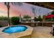 The backyard oasis with a spa, outdoor grill and beautiful twilight sky at 17363 W Lisbon Ln, Surprise, AZ 85388