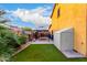 Green backyard with an exterior storage shed and a covered patio area with pavers at 17363 W Lisbon Ln, Surprise, AZ 85388