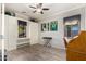 Bright bedroom featuring built-in cabinets, shelving, hardwood flooring and ceiling fan at 17363 W Lisbon Ln, Surprise, AZ 85388