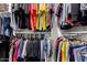 Walk-in closet features built-in shelving and hanging racks for clothes storage at 17363 W Lisbon Ln, Surprise, AZ 85388