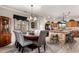Dining area features a chandelier, view of kitchen island, and wood-look flooring at 17363 W Lisbon Ln, Surprise, AZ 85388