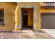 Inviting entrance with decorative front door, stone accents, and warm lighting at 17363 W Lisbon Ln, Surprise, AZ 85388