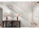 Inviting entryway featuring a staircase with white railings and decorative table lamps on an ornate console table at 17363 W Lisbon Ln, Surprise, AZ 85388