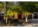 Beautiful single-story home with desert landscaping, and warm lighting, creating an inviting ambiance at 17363 W Lisbon Ln, Surprise, AZ 85388