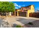 Charming two-story home with a two-car garage, mature tree, and an inviting entrance at 17363 W Lisbon Ln, Surprise, AZ 85388