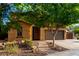 Single-story home with mature trees, desert landscaping, and an inviting entrance at 17363 W Lisbon Ln, Surprise, AZ 85388